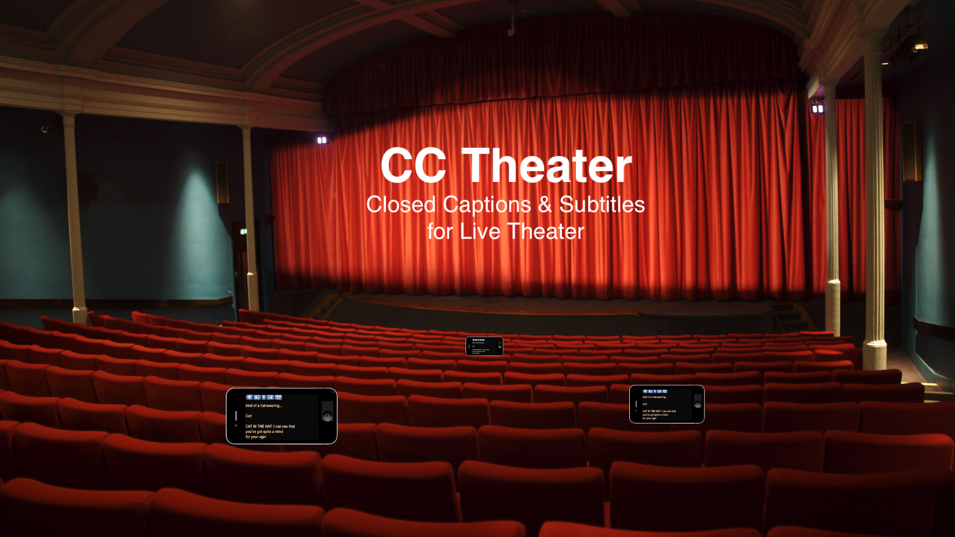 A live theater interior. There are iphones at a few seats showing captions.